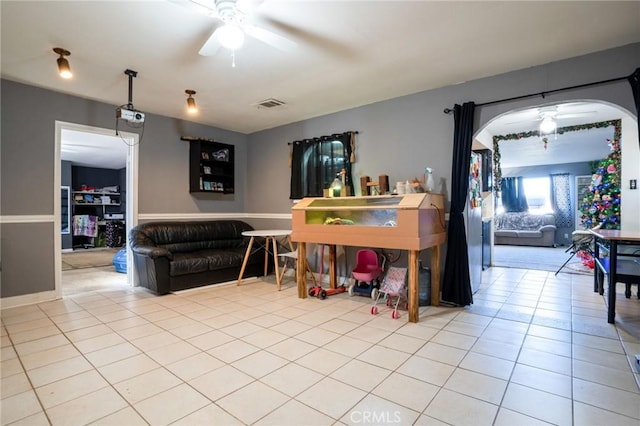 game room with light tile patterned floors and ceiling fan