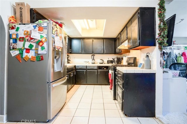 kitchen with tile counters, stainless steel fridge with ice dispenser, light tile patterned floors, and black electric range