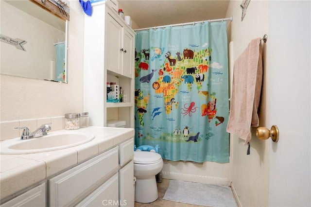 full bathroom featuring tile patterned flooring, vanity, shower / bath combination with curtain, and toilet