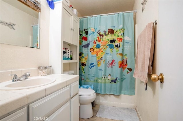 bathroom with toilet, shower / bath combo, and vanity