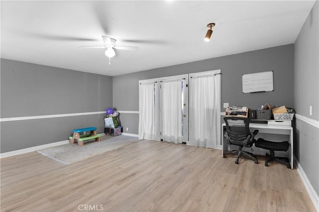 office with light wood finished floors, baseboards, and a ceiling fan