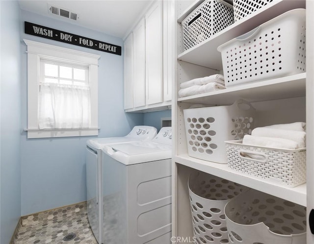 clothes washing area featuring washer and dryer