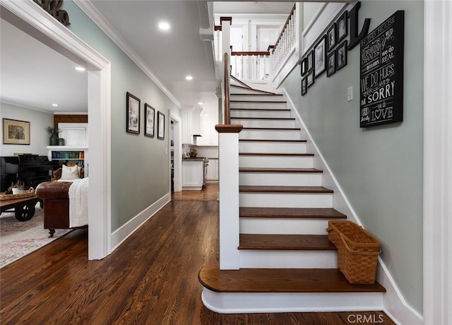 stairway with hardwood / wood-style flooring and ornamental molding