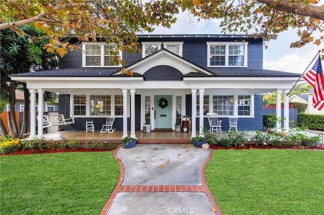 view of front of house with covered porch and a front yard