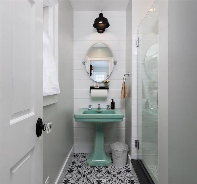 bathroom with tile patterned floors and a shower with shower door