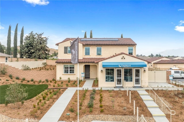 mediterranean / spanish-style home featuring solar panels