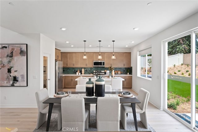 dining area featuring light hardwood / wood-style floors and sink