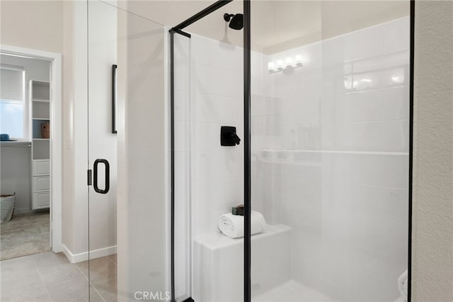 bathroom featuring tile patterned flooring and a shower with shower door