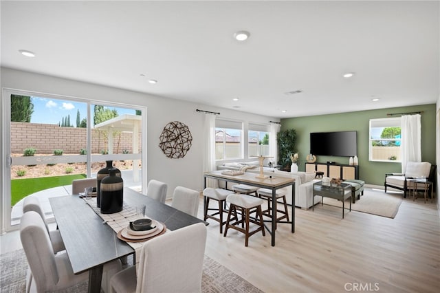 dining space featuring light hardwood / wood-style flooring and plenty of natural light