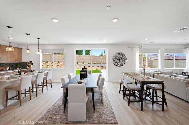 dining space with light hardwood / wood-style flooring