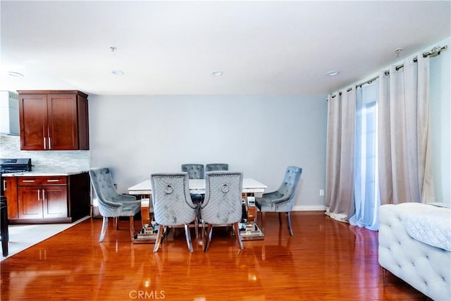 dining space featuring wood-type flooring