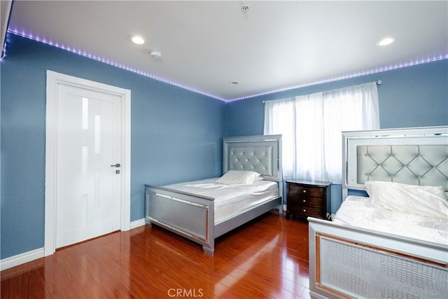 bedroom featuring dark hardwood / wood-style flooring