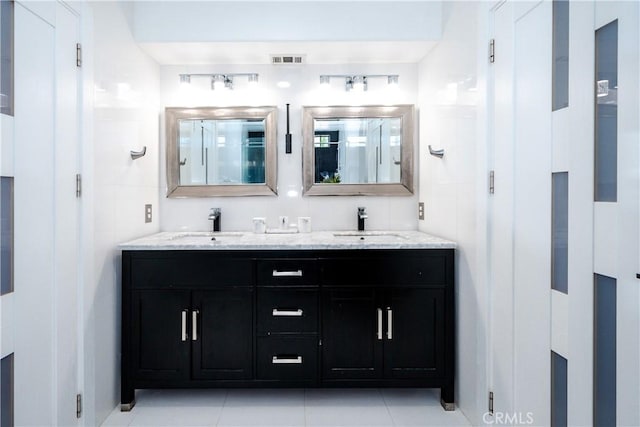 bathroom with tile patterned flooring and vanity