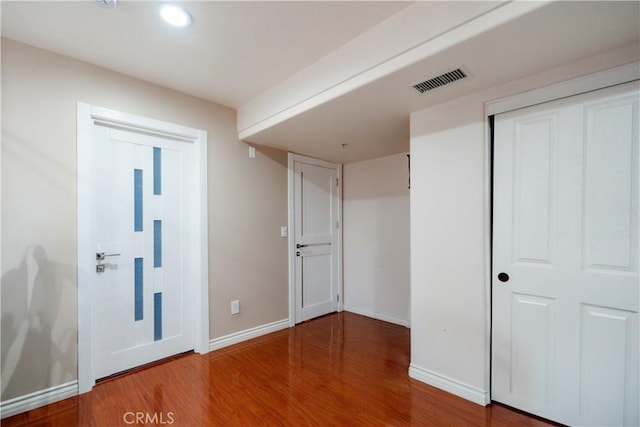 unfurnished bedroom with a closet and hardwood / wood-style floors