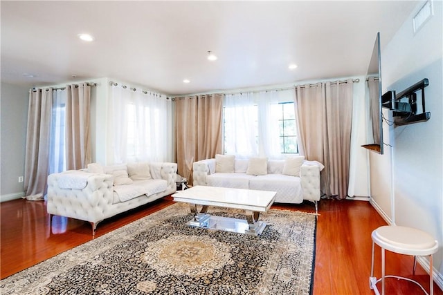 living room with dark hardwood / wood-style flooring