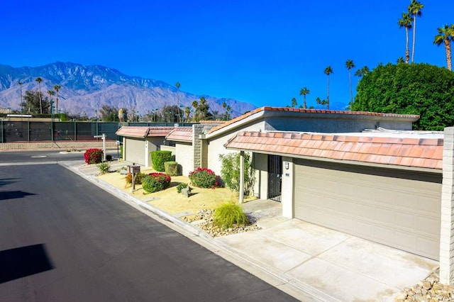 view of front of home with a mountain view and a garage