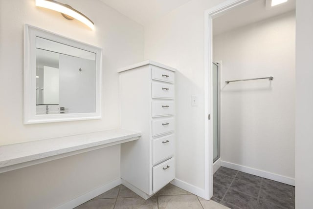 bathroom with tile patterned flooring and an enclosed shower