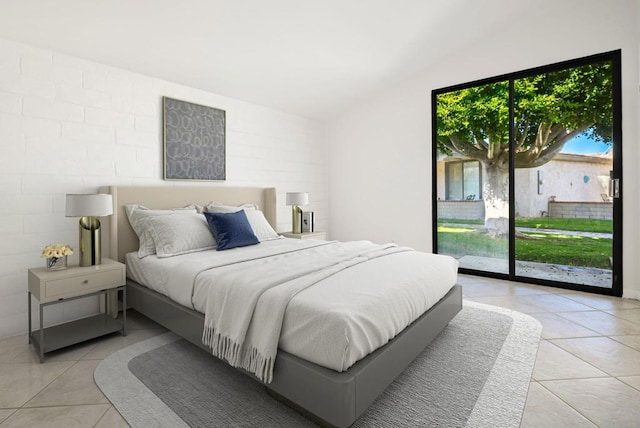 tiled bedroom with lofted ceiling and access to exterior