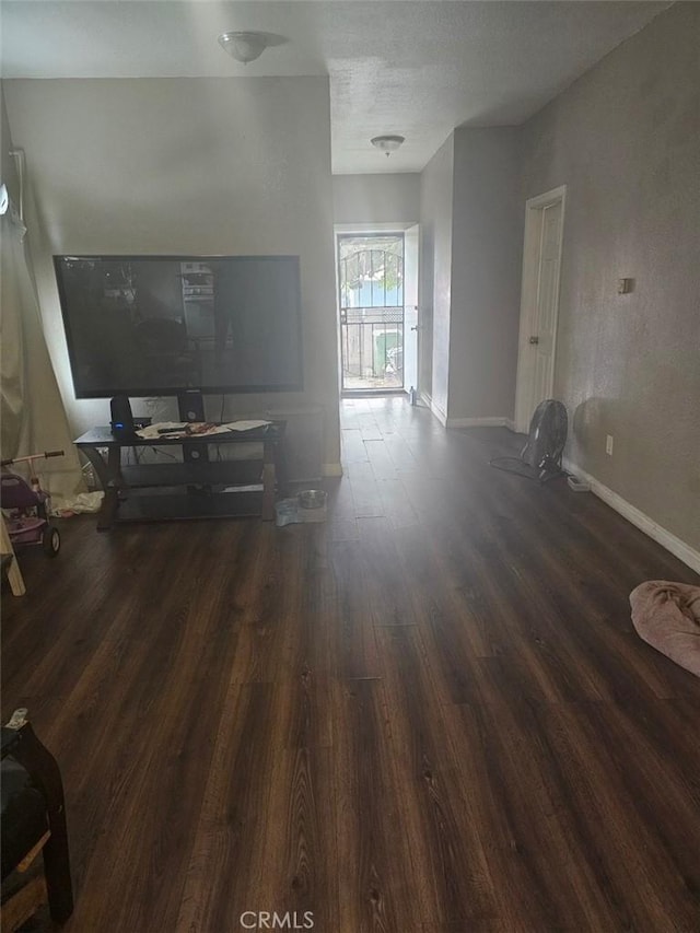 unfurnished living room with dark hardwood / wood-style flooring