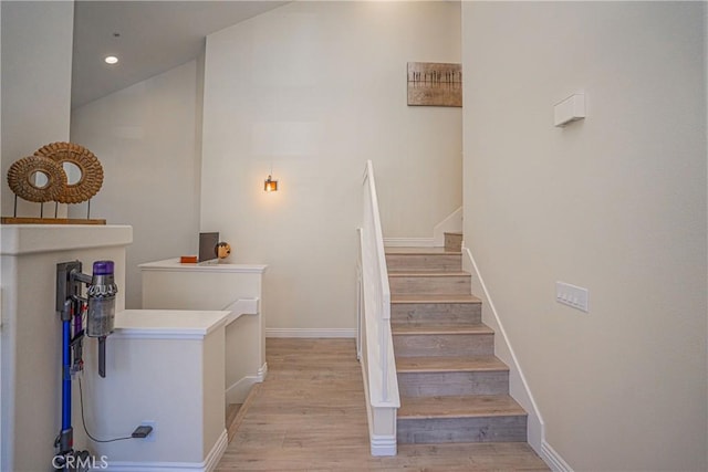 stairs featuring hardwood / wood-style flooring