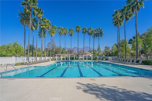 view of pool with a mountain view and a patio