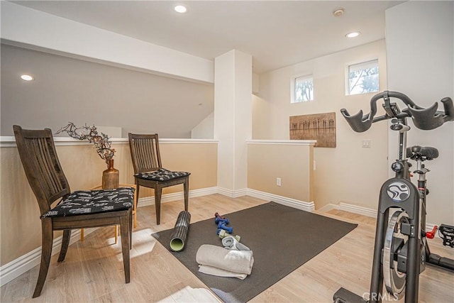 exercise room with light wood-type flooring