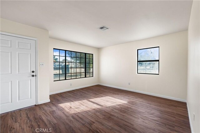 unfurnished room featuring dark wood-type flooring