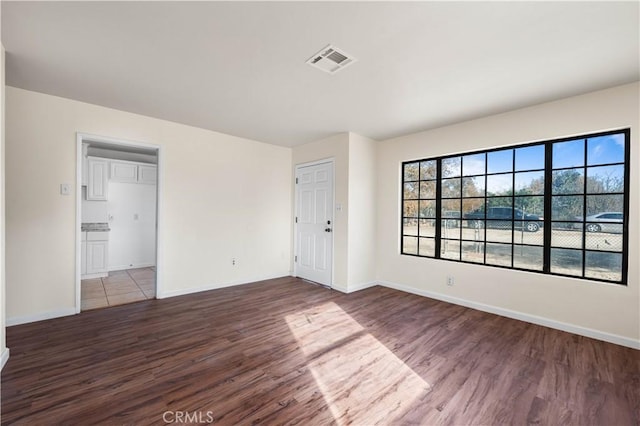 empty room with hardwood / wood-style flooring