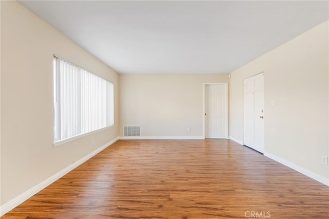 empty room with wood-type flooring