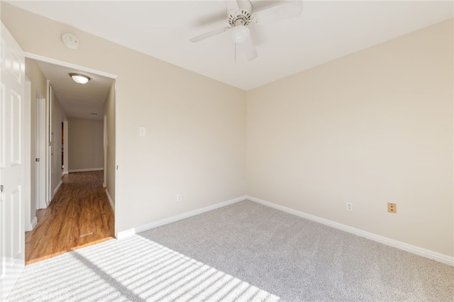 unfurnished room featuring ceiling fan and carpet