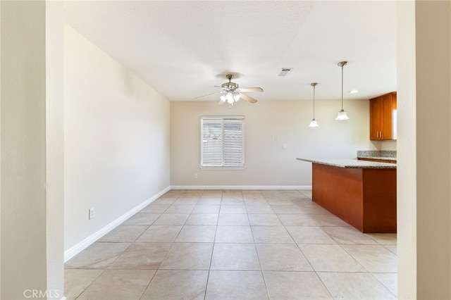 kitchen with ceiling fan, light tile patterned floors, kitchen peninsula, and hanging light fixtures