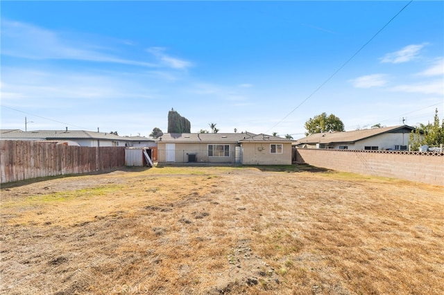 back of house with a lawn