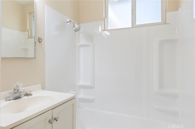 bathroom with vanity and shower / washtub combination