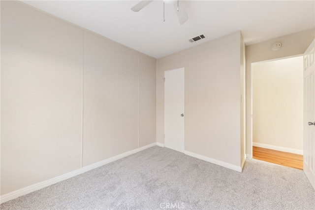 carpeted empty room featuring ceiling fan