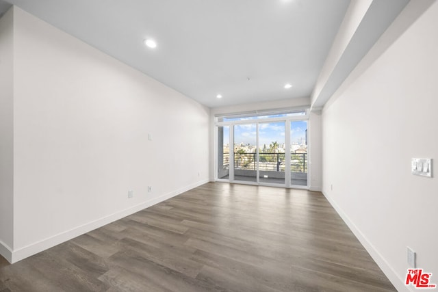 spare room featuring dark wood-type flooring