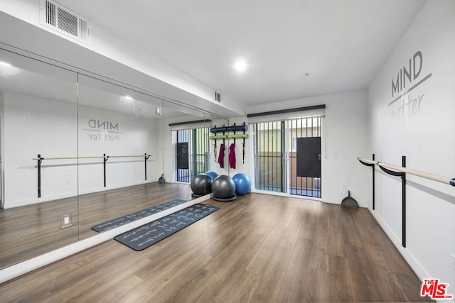 exercise area featuring hardwood / wood-style floors