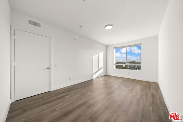 empty room featuring dark hardwood / wood-style floors