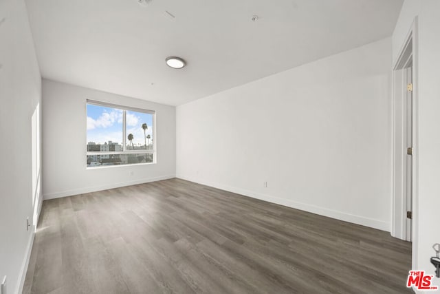 unfurnished room with dark hardwood / wood-style floors