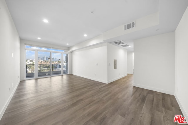 empty room with dark hardwood / wood-style flooring