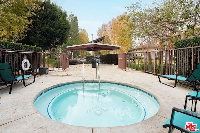 view of pool with a community hot tub