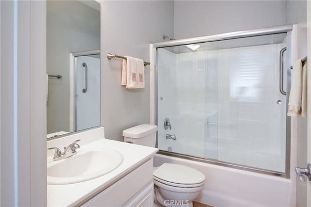 full bathroom with vanity, toilet, and enclosed tub / shower combo