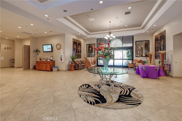 interior space featuring ornamental molding, a tray ceiling, and a notable chandelier