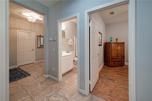 hallway featuring light tile patterned floors