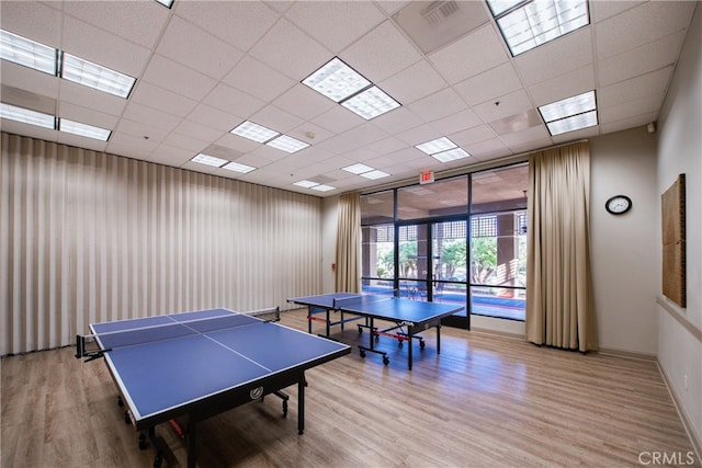 game room with a drop ceiling and wood-type flooring