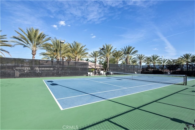 view of tennis court with basketball hoop