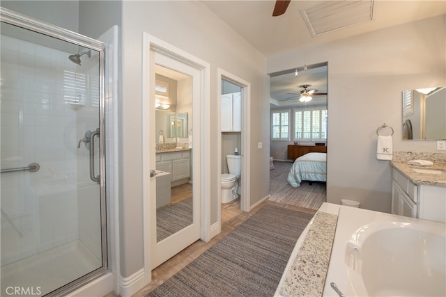 bathroom featuring tile patterned floors, vanity, toilet, and a shower with door