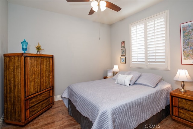 bedroom with ceiling fan and hardwood / wood-style floors