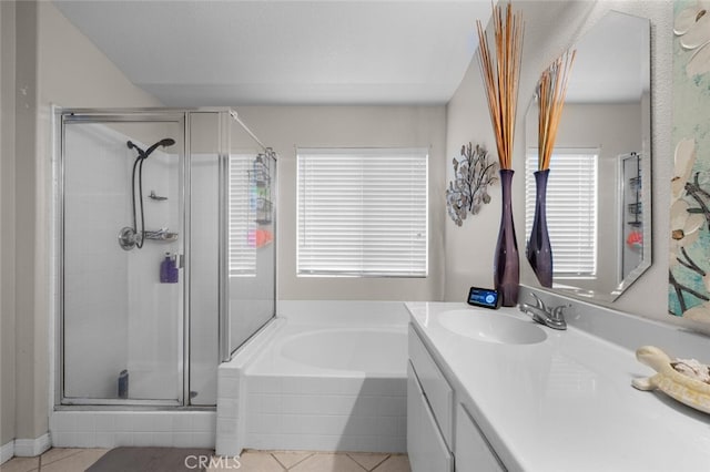 bathroom with vanity, tile patterned floors, a wealth of natural light, and separate shower and tub