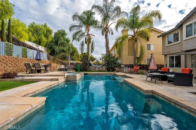 view of pool featuring a patio area, an outdoor hangout area, and an in ground hot tub