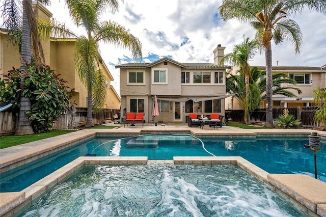 view of swimming pool with outdoor lounge area, an in ground hot tub, and a patio